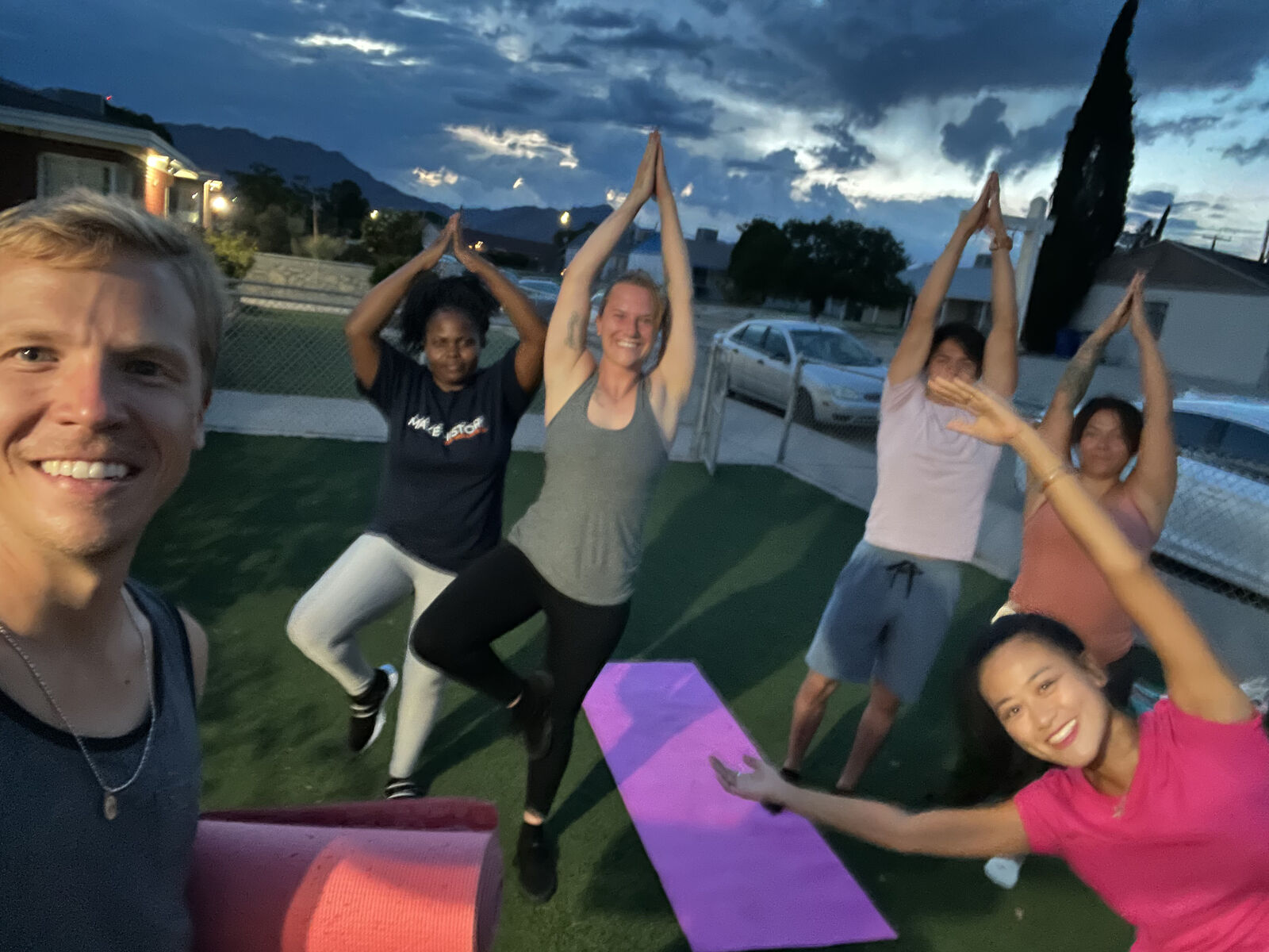 Mathuresh Das teaching an outdoor Manji Yoga class at dusk