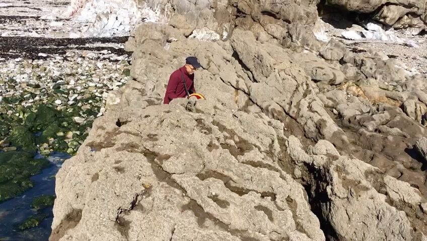 Sitting on the rocks by the water